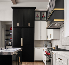 Black and brass kitchen with marble and timber beams